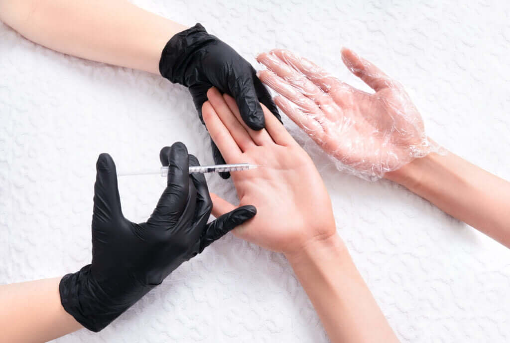 Portrait of a female getting injection on her hands | Hyperhidrosis Treatment | PhillyMedClub in Philadelphia, PA