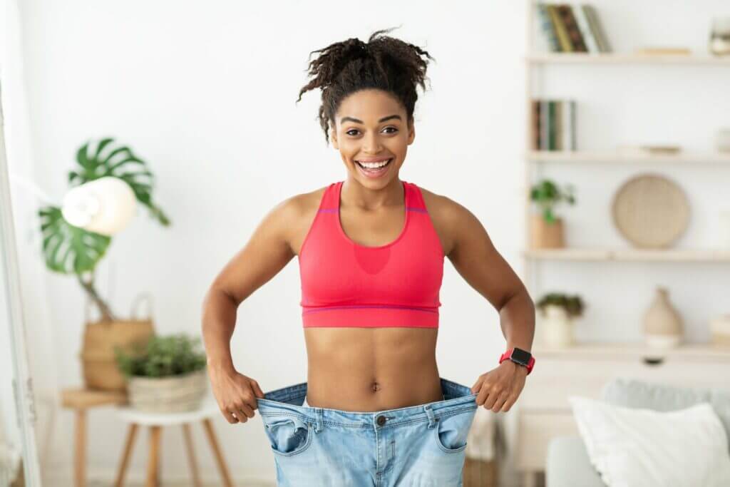 a curly hair lady happy with her weight loss | Weight Management in Philadelphia, PA | PhillyMedClub