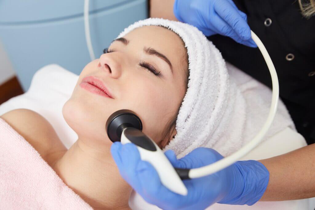 A Woman getting treatment on face by a device | Non-Invasive Skin Rejuvenation in Philadelphia, PA | PhillyMedClub