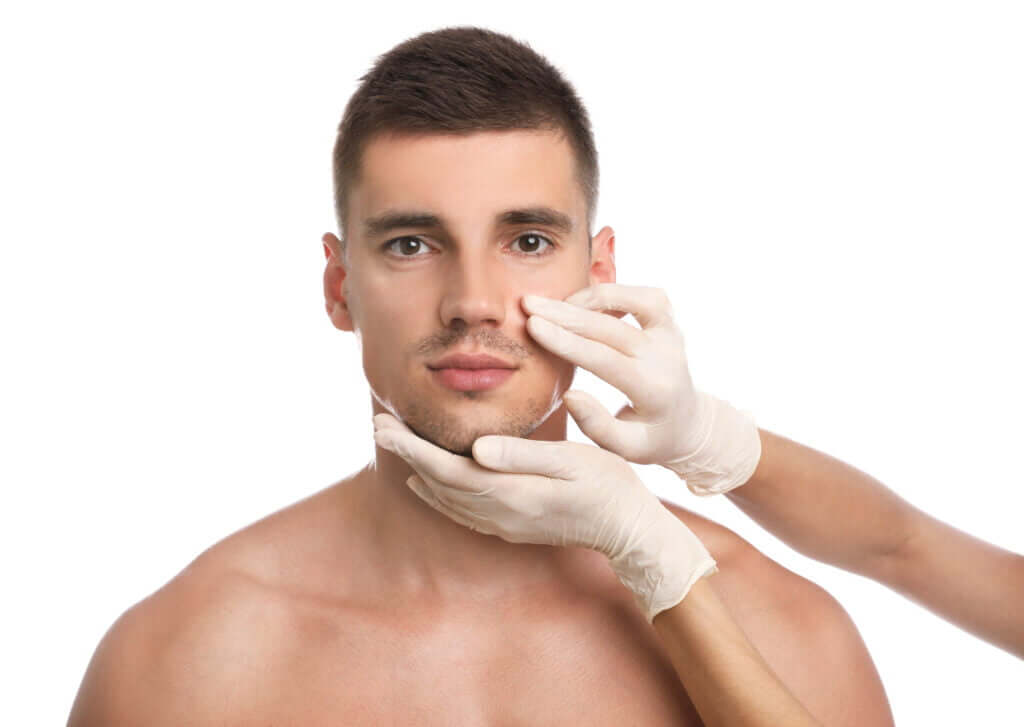 Doctor examining man's face for cosmetic surgery on white background | Medical Spa in Philadelphia, PA | PhillyMedClub